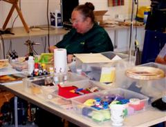 Jennie at her worktable and surrounded by colour